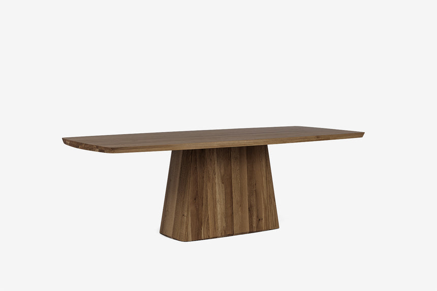 Drewniany stół widziany z boku, z szerokim blatem i centralną podstawą.